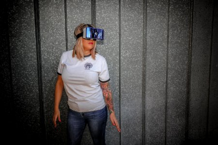 Photograph Of Woman Wearing Vr Glass In Front Of Wall photo