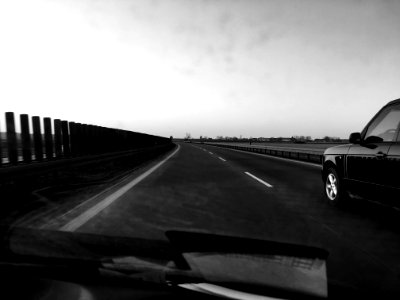 Grayscale Photography Of Car On Road photo