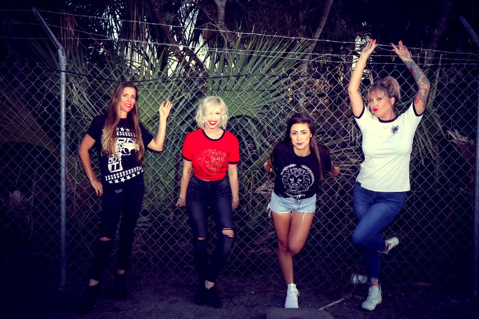 Four Woman Leaning On Chain Link Fence photo