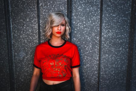 Woman In Red Shirt Standing Near Wall photo