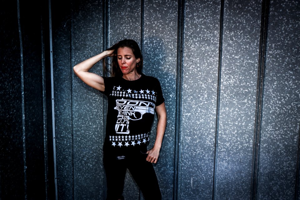 Woman Wearing Black Shirt And Pants Near Gray Wall