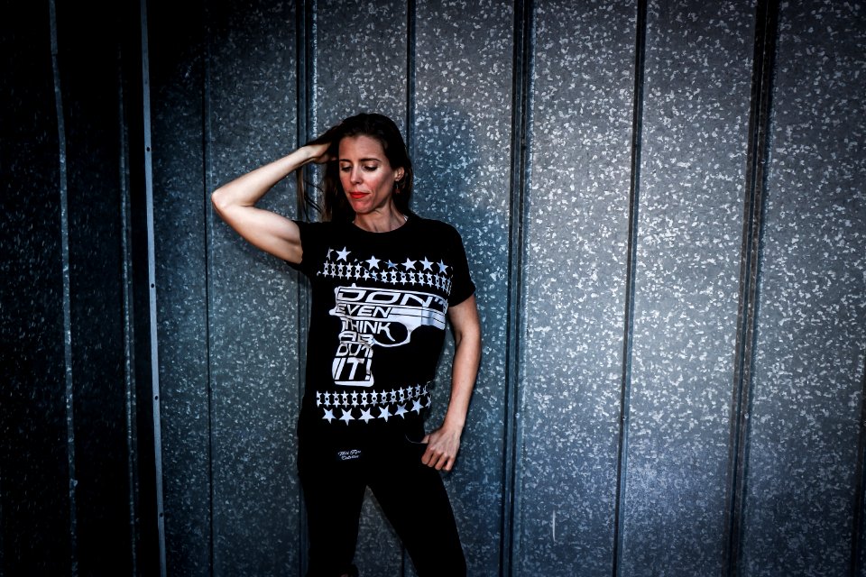 Woman Wearing Black Shirt And Pants Near Gray Wall photo