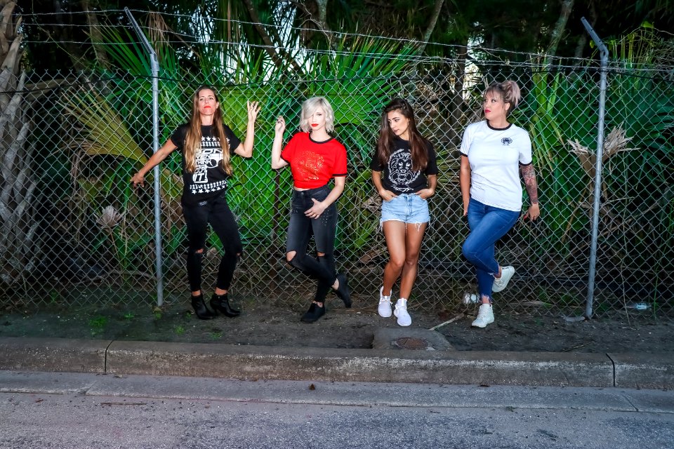 Group Of Women Standing In Front Metal Fence photo