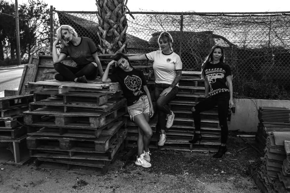 Four Women Leaning And Sitting On Pallets photo