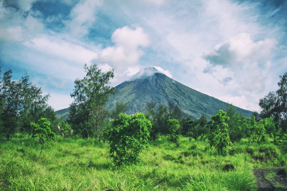 Landscape Photography Of Mountain Under Cloudy Sky