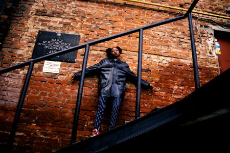 Woman In Black Jacket Standing On The Stairs photo