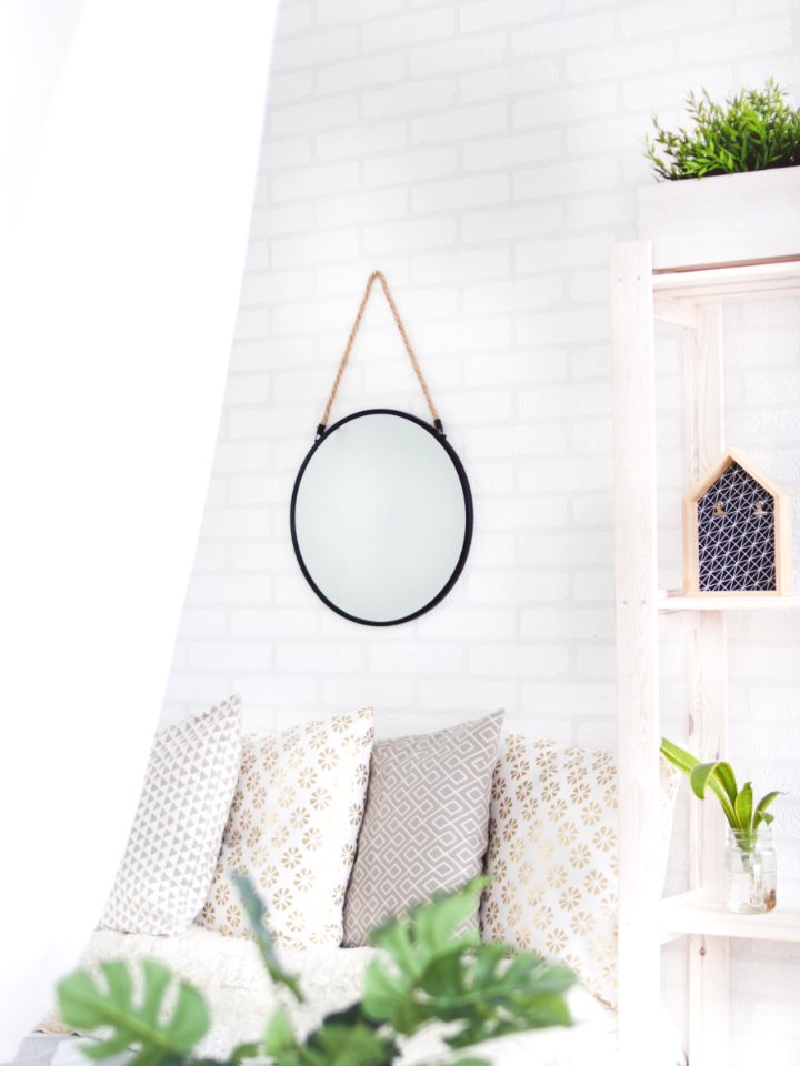 Round Black Framed Mirror On The Wall