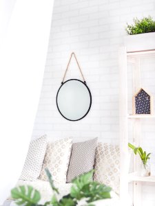 Round Black Framed Mirror On The Wall