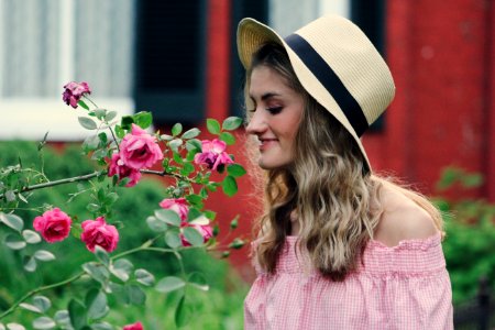 Photo Of Woman Smelling Flowers photo
