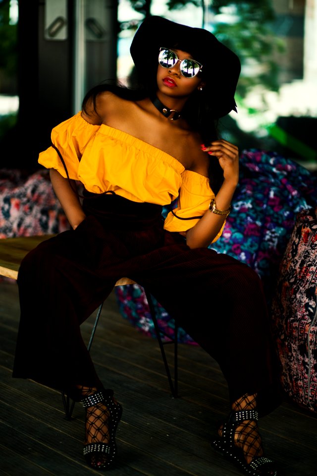 Woman In White Tube Top And Brown Pants