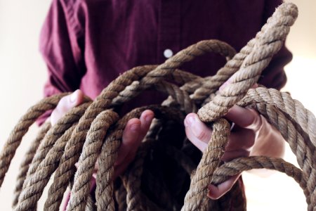 Close-up Photography Of Man Holding A Rope photo