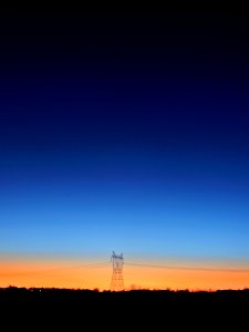 Black Transmitter Tower Under Blue And Orange Sky