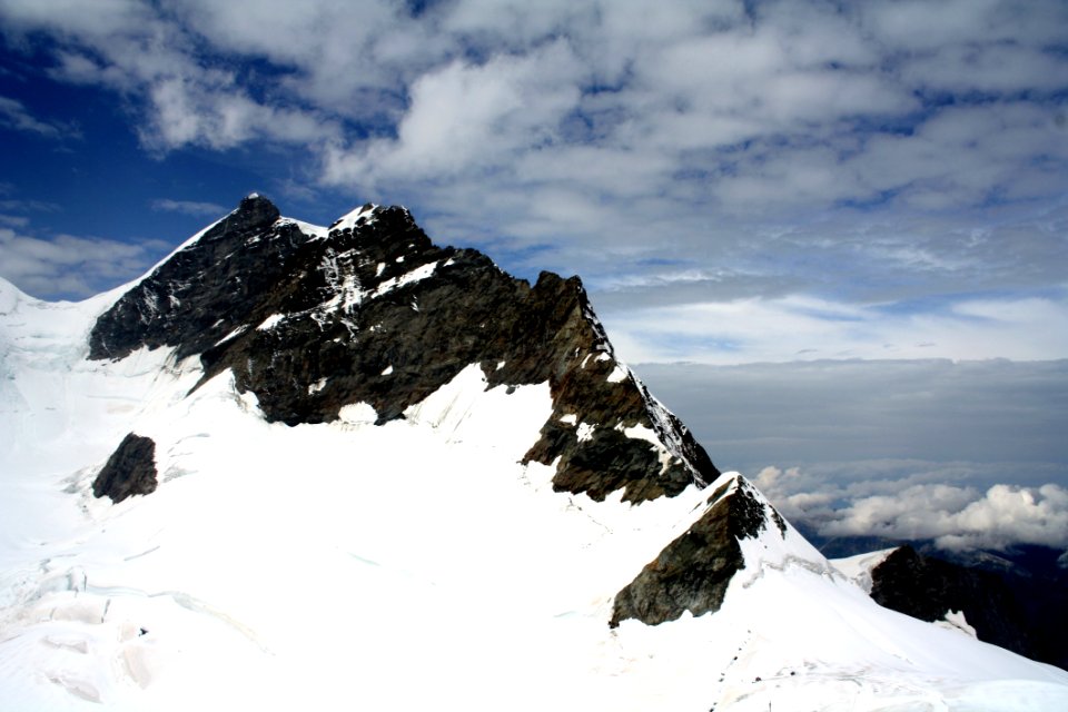 Snow Capped Mountain Under Cloudy Sky