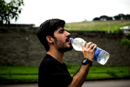 Man Wearing Black Shirt Drinking Water photo