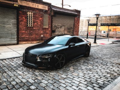 Black Audi A-series Parked Near Brown Brick House photo