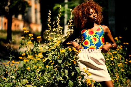 Photography Of Woman Wearing Blue Yellow And Red Floral Tank Top Standing