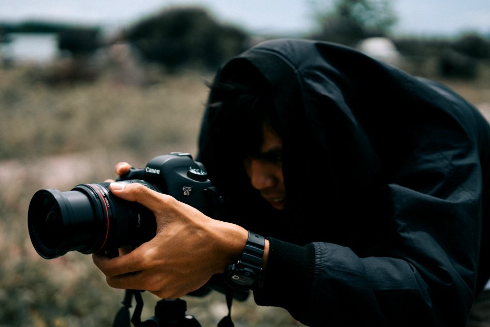 Black Canon Dslr Camera On Hand