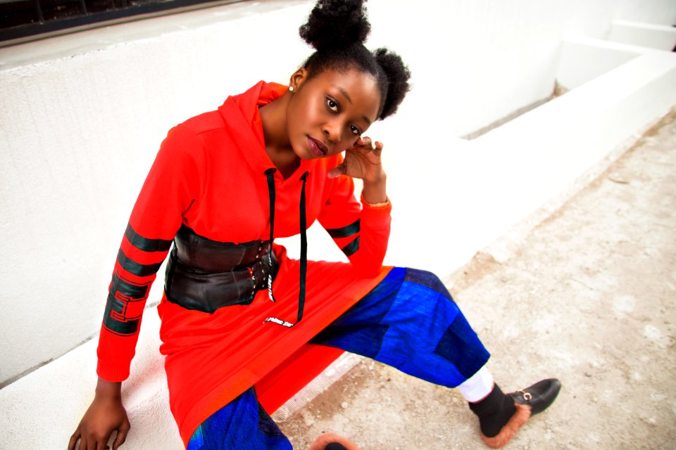 Women Sitting On Street In Red And Blue Dress