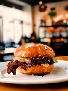 Selective Focus Photography Of Burger On White Ceramic Plate