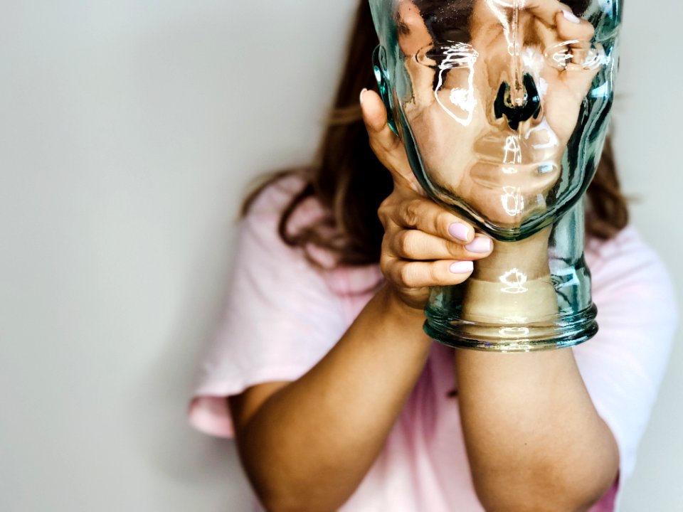 Womans Hand Inside Glass Bottle