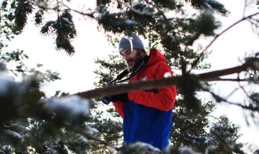 Man In Red And Blue Jacket Near Trees photo