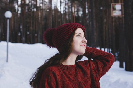 Woman Wearing Maroon Bobble Beanie On Winter Day photo