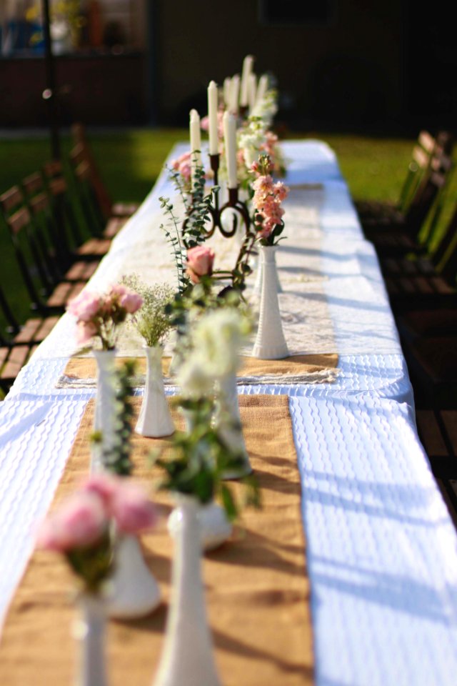 White Candle Holder On Brown Tablecloth Taken At Daytime