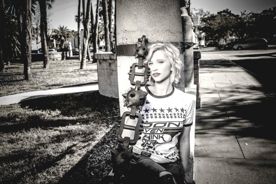 Woman Wearing Crew-neck Shirt Leaning Against The Post