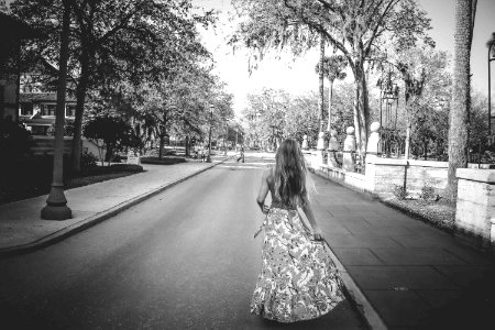 Woman In Floral Dress Standing On Road photo