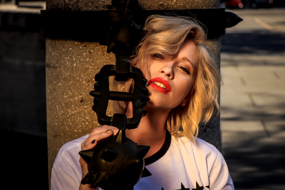 Woman Wearing White Crew-neck Shirt Holding Black Weapon