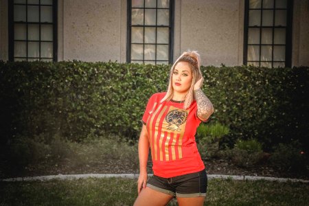 Woman Wearing Brown And Red T-shirt Standing Near The House photo