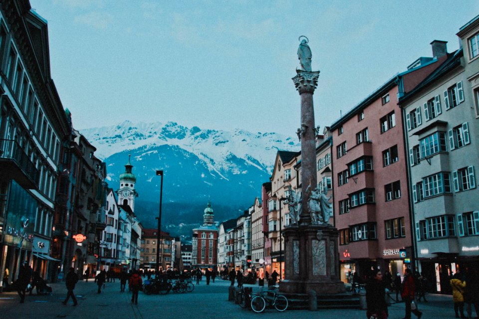 Brown And White Concrete Buildings Near Snow Coated Mountain photo