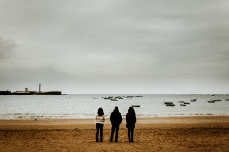 Three Person Standing Near The Seashore photo