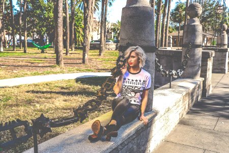 Woman In White And Black T-shirt And Pants Sitting On Beam photo