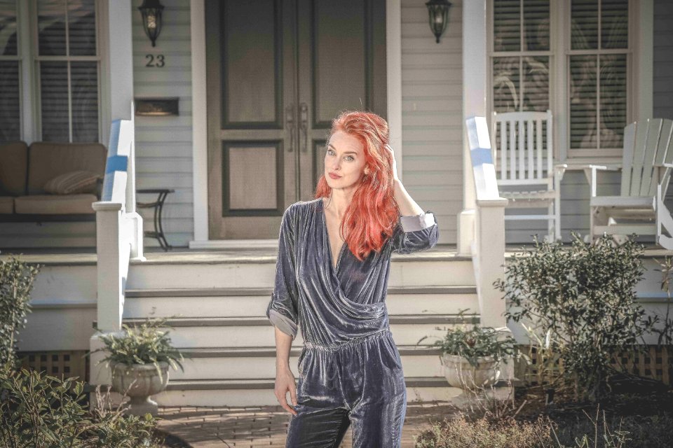 Woman Wearing Gray Peplum Elbow-sleeved Jumpsuit Standing In Front Of House