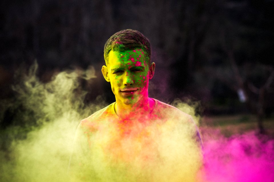 Man Painted With Green And Purple Paints Photo