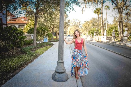 Woman Wearing Red And Blue Floral Tank Dress Beside Concrete Road photo
