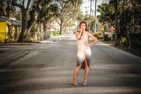 Woman Wearing Grey And Beige Dress Standing On Center Of Street