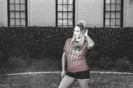 Woman Wearing Red Crew-neck Shirt With Black Short Shorts photo