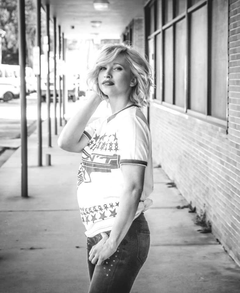 Woman Holding Hair And Jeans Pocket Grayscale Photo