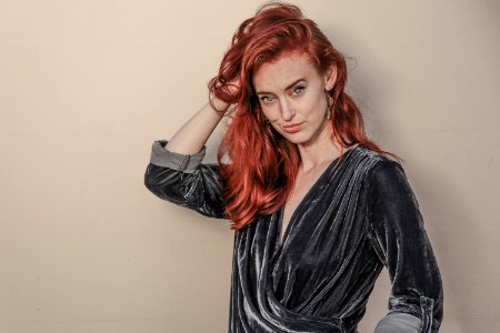 Red Haired Woman In Black Long-sleeved Top photo