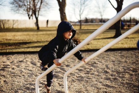 Girl In Black Hoodie And Pants Holding On White Metal Handrail At Daytime photo