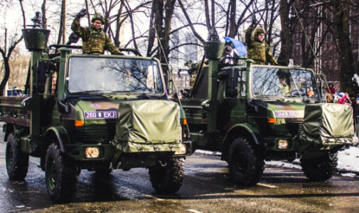 Soldiers Riding On Trucks photo