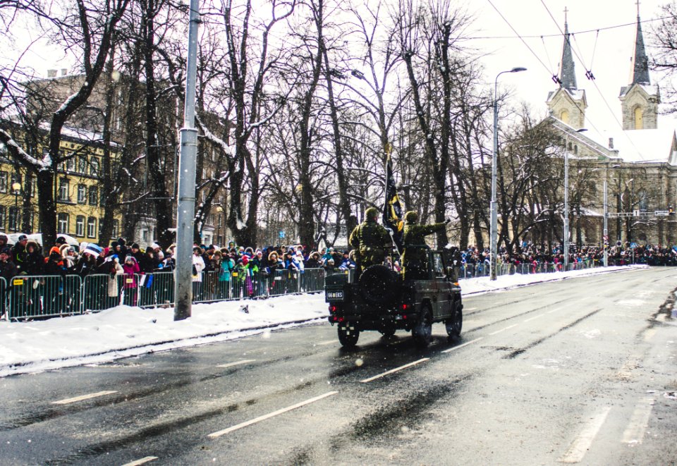 Soldiers Riding A Vehicle During A Parade