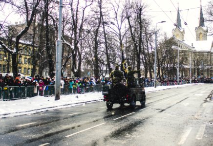 Soldiers Riding A Vehicle During A Parade