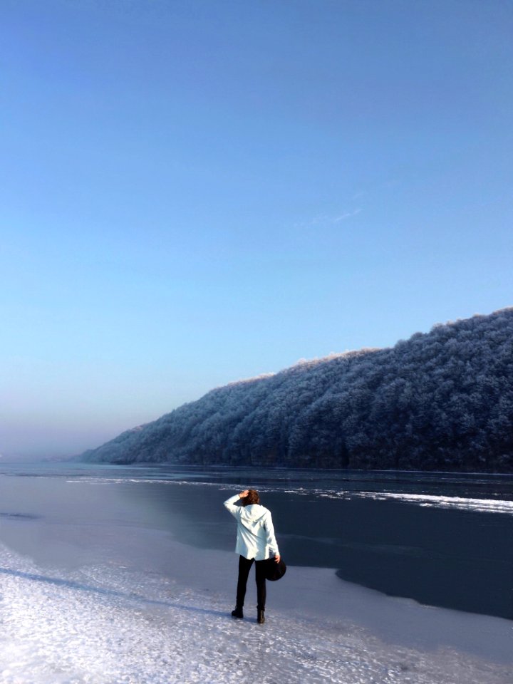 Man Wearing Black Pants Standing On Beach Shore photo