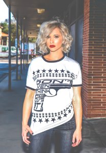 Woman In White And Black Gun-printed Crew-neck Shirt photo