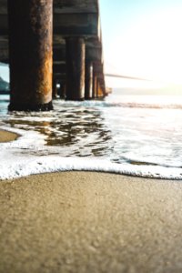 Closeup Photo Of Seashore Near Bridge photo