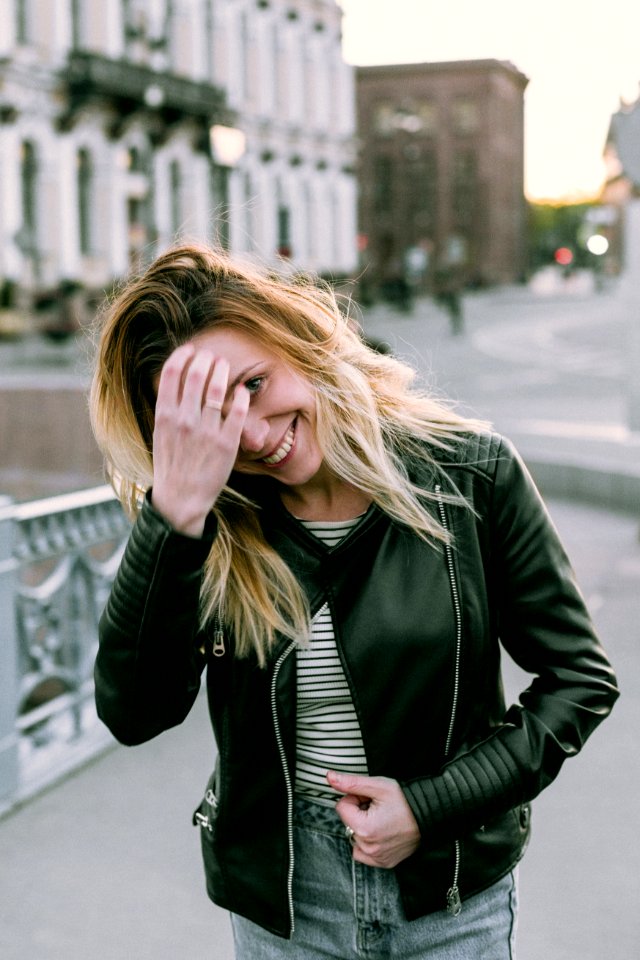 Photo Of Woman Wearing Black Zip-up Leather Jacket And White And Black Striped Shirt