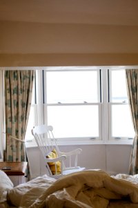 Photo Of Empty White Rocking Chair Beside Window photo